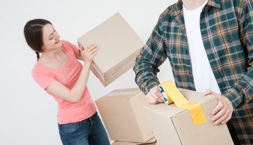 Office relocation with desks, boxes, and equipment being loaded for transport