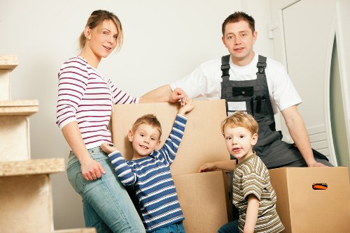 Movers carrying furniture through a narrow stairwell in Stroud Green