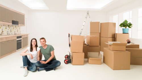 Careful unpacking of household items in a Stroud Green flat