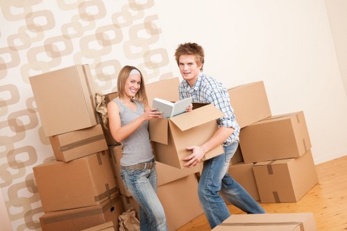 Local movers handling commercial equipment on a narrow Stroud Green street