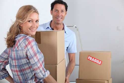 Movers transporting items through a North London flat building