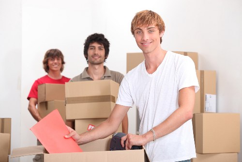 Movers carrying furniture through a Stroud Green property entrance